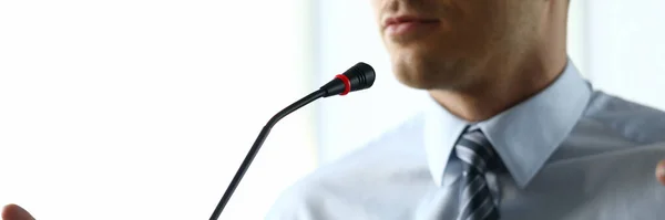 Man at home speaks in front microphone in video