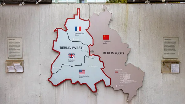 Berlin, Almanya - 8 Kasım 2019: Charlie Kontrol Noktası yakınlarındaki gri duvarda Berlin Duvarının işareti. Sovyet işgali sırasında bölünmüş Berlin haritası..