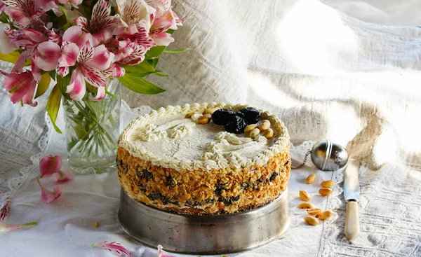 cake with quark cream, vanilla, cheese cake from pastry with prunes and peanuts