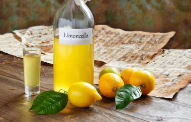 Italian alcoholic beverage, Limoncello on wooden table clipart