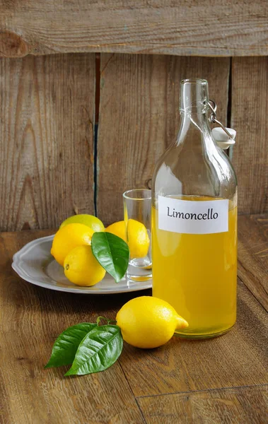 Italian alcoholic beverage, Limoncello on wooden table