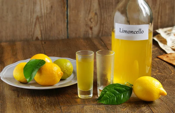 Italian alcoholic beverage, Limoncello on wooden table