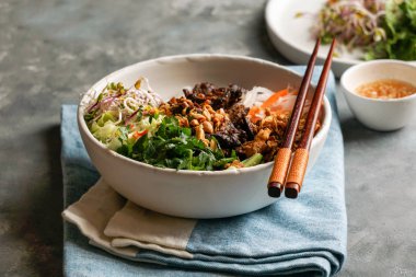Bir kase geleneksel Vietnam erişte salatası - Bun Bo Nam Bo, sığır eti, pirinç eriştesi, taze otlar, sebze turşusu ve balık soslu.