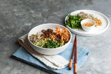 Bir kase geleneksel Vietnam erişte salatası - Bun Bo Nam Bo, sığır eti, pirinç eriştesi, taze otlar, sebze turşusu ve balık soslu.