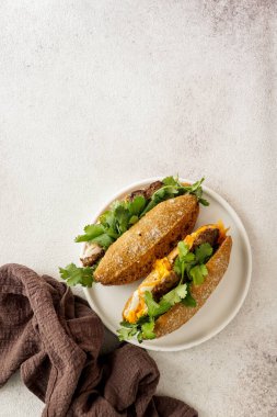 Banh Mi Sandwich,  typical Vietnamese sandwich, coriander leaf, pate, meat, cucumber, pickled carrots, and pickled daikon, on the banana leaf clipart