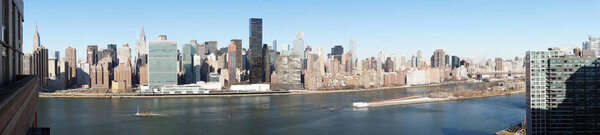 Aerial Panorama of Midtown Manhattan and East River from a high-rise building in Long Island City, Queens.