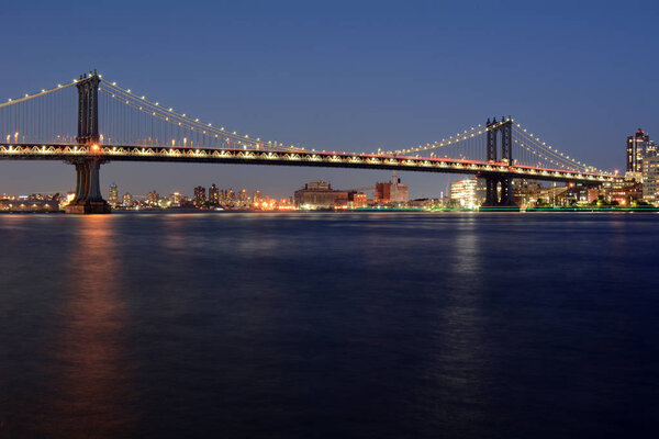 Manhattan Bridge at night from East River Park in Manhattan.
