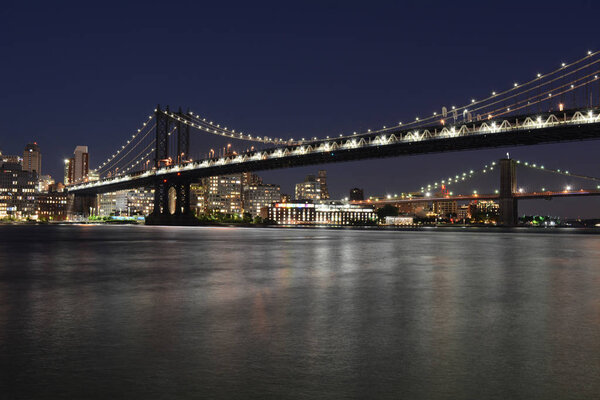 Manhattan Bridge facing Brooklyn from East River Park in Manhattan at night.