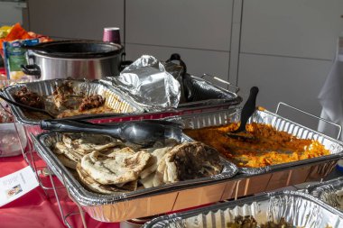 Potluck Food on Tables in Office for Thanksgiving clipart