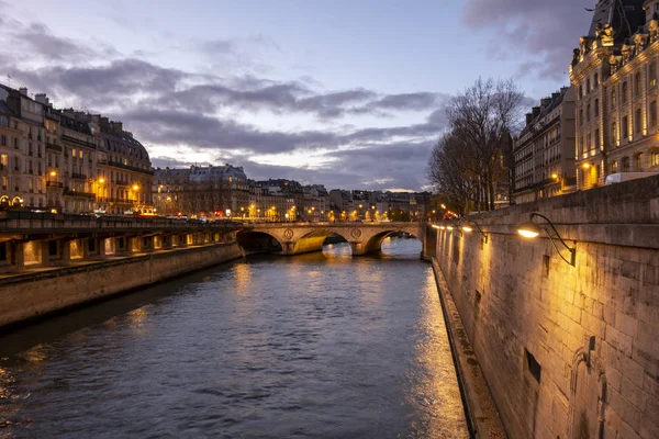 Seine River and the Pont au Change Bridge at Dusk in Paris, France