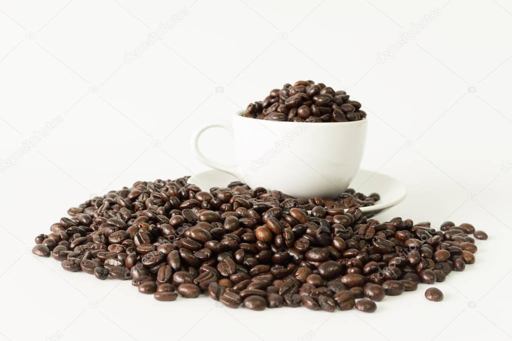 Coffee beans in coffee cup on white 