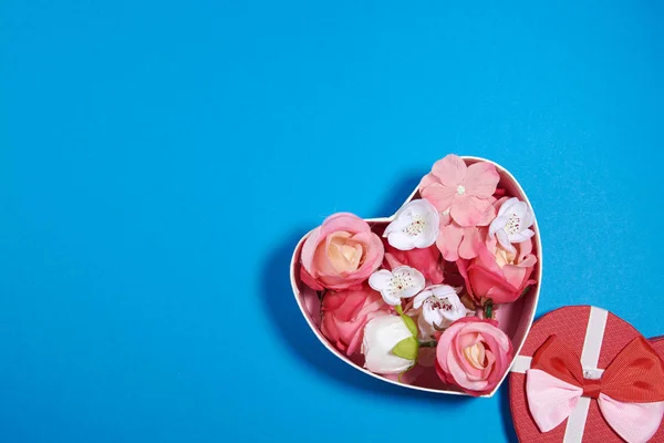 The Background Of Valentine\'s Day. Gifts, flowers, heart, box in pastel blue colors. The Concept Of Valentine\'s Day. Flat sunbed, top view, copy space