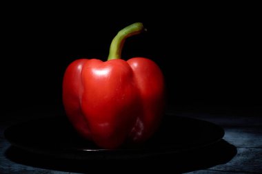 siyah bir arka plan üzerinde kırmızı tatlı biber