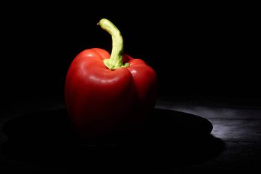 siyah bir arka plan üzerinde kırmızı tatlı biber