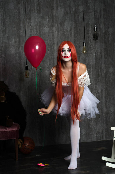 a girl in a clown costume with scary makeup