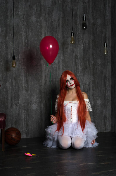 a girl in a clown costume with scary makeup