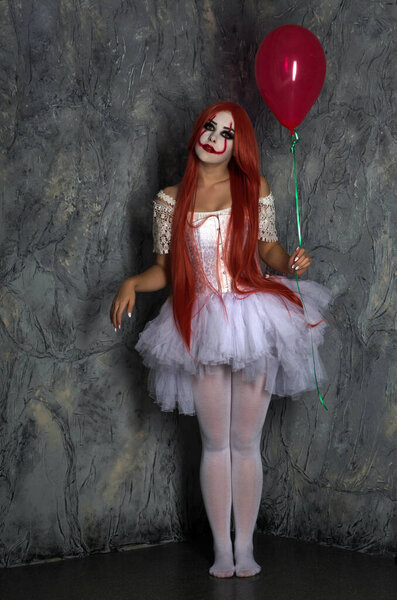 a girl in a clown costume with scary makeup