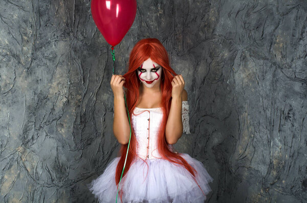 a girl in a clown costume with scary makeup