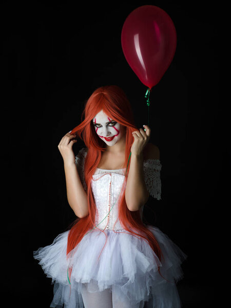 a girl in a clown costume with scary makeup