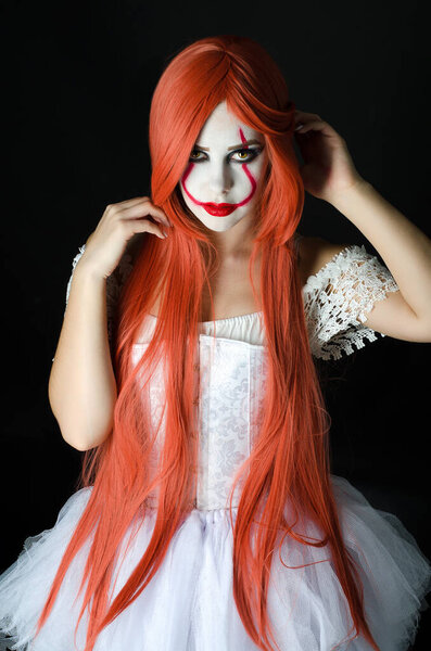 a girl in a clown costume with scary makeup