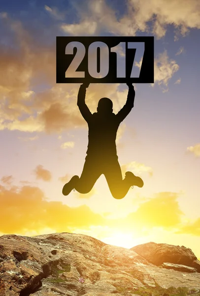 Hiker jumps up in celebration of the New Year 2017. — Stock Photo, Image