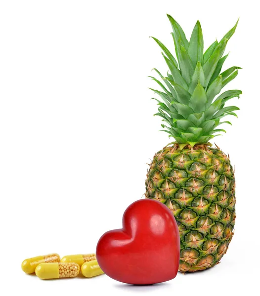Żółte kapsułki pigułki z serca i ananasem — Zdjęcie stockowe