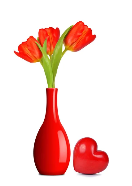 Bouquet of red tulips in vase with heart — Stock Photo, Image