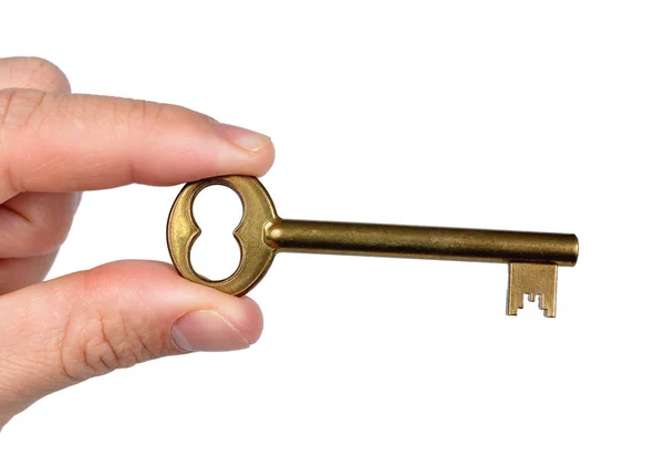 Рука тримає золотий ключ дверей — стокове фото