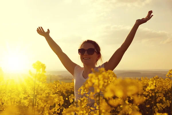 Young happy woman in the rapeseed field — Stock Photo, Image
