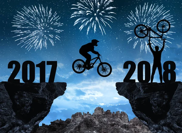 Silhouette cyclist jumping into the New Year 2018. — Stock Photo, Image