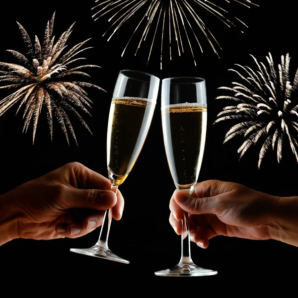 New Year's fireworks with clinking glasses of champagne in hands. — Stock Photo, Image