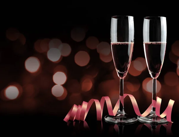 Two glasses with champagne and ribbon. — Stock Photo, Image