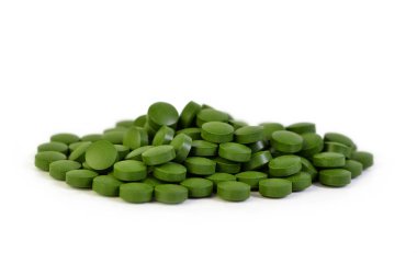 Beyaz bir arka plan üzerinde izole yeşil Spirulina Tablet.