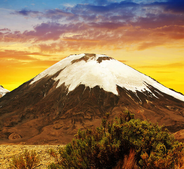 Volcano Parinacota at sunset in Lauca National Park high on the Altiplano of northern Chile, South America.