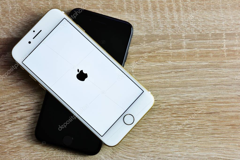 CHLUMCANY, CZECH REPUBLIC, DECEMBER 08, 2017: Apple iPhone 7 in the color gold and black on wooden background.