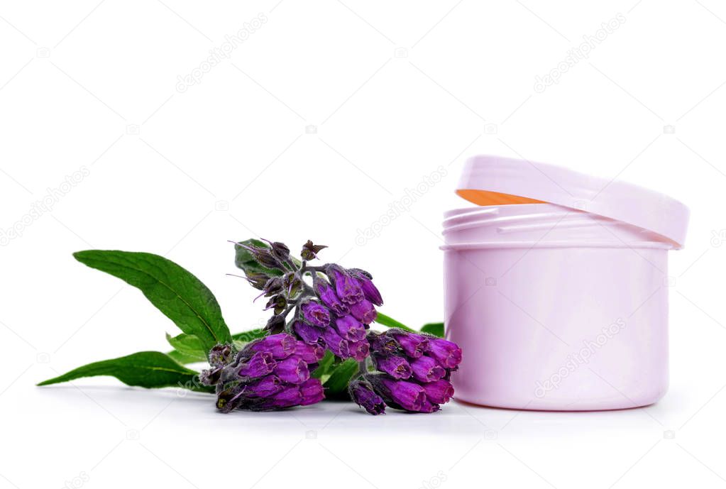 Comfrey cream with fresh Symphytum Officinale plant isolated on white background.
