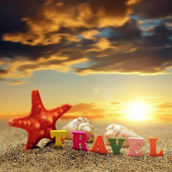 Colorful word Travel and sea shell with starfish on the tropical sand beach at sunset. Summer vacations concept.