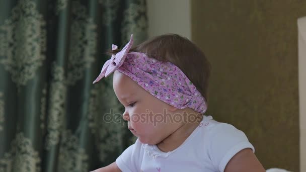 A little girl reading a book at home — Stock Video