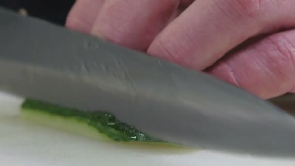 Cocinero profesional en la cocina corta un pepino — Vídeo de stock