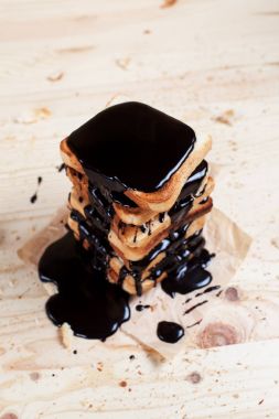 çikolata ile ahşap arka plan üzerinde bir ahşap kesme tahtası üzerinde kağıda döktü bir muz ile tost