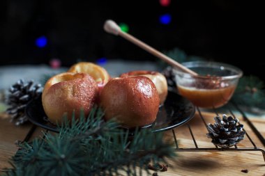 Yeni yıl, çam ağacı, koniler, tatlım yılbaşı ışıkları siyah bir zemin üzerine pişmiş elma