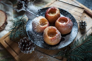 Yeni yıl, çam ağacı, koniler, pişmiş elma tatlım siyah bir arka plan üzerinde
