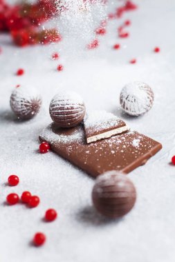 çikolata şekerleme, çikolata ve gri arka plan ve pudra şekeri kırmızı meyveler yuvarlak