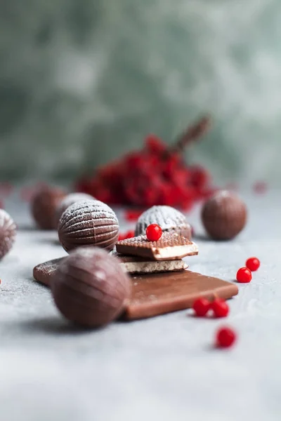 巧克力圆形糖果, 巧克力棒和红色浆果的灰色背景和糖粉 — 图库照片