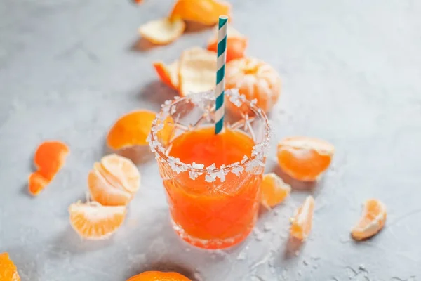orange cocktails, salt and tangerines on a light background