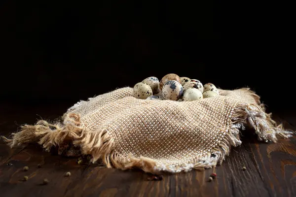 Ovos de codorna em um guardanapo em uma mesa de madeira — Fotografia de Stock