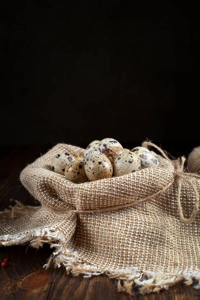 Quail eggs on a napkin on a wooden table — Stock Photo, Image