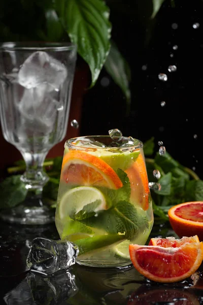 karanlık bir arka plan üzerine bir bardak limonata. sprey ve hareket