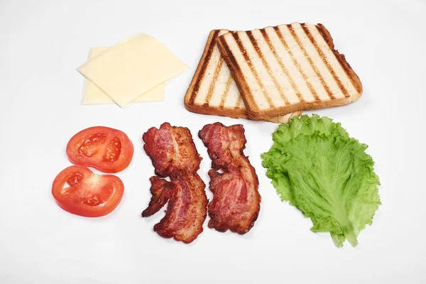 Ingredients for making sandwich. fresh vegetables, tomatoes, bread, becon. Isolated on white background, top view, copy space — Stock Photo, Image