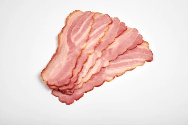 Sliced pork bacon on a white background — Stock Photo, Image